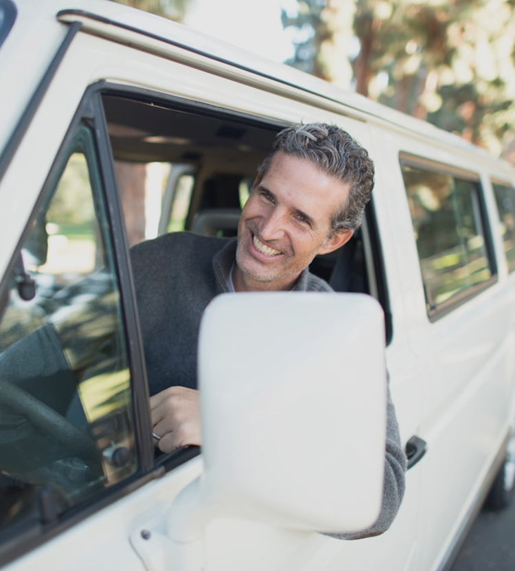 Smiling Man Leaning out Car Window